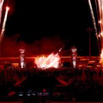 Live band performing under stage lighting at an outdoor music festival