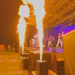 Flame machines shooting fire at a concert stage